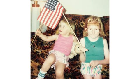 Melissa Blake and her sister wave American flags.