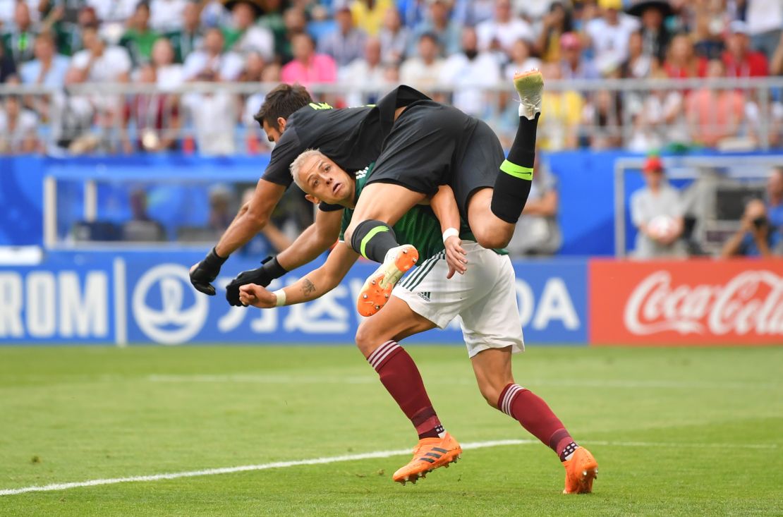 Javier Hernandez of Mexico collides with Alisson of Brazil.