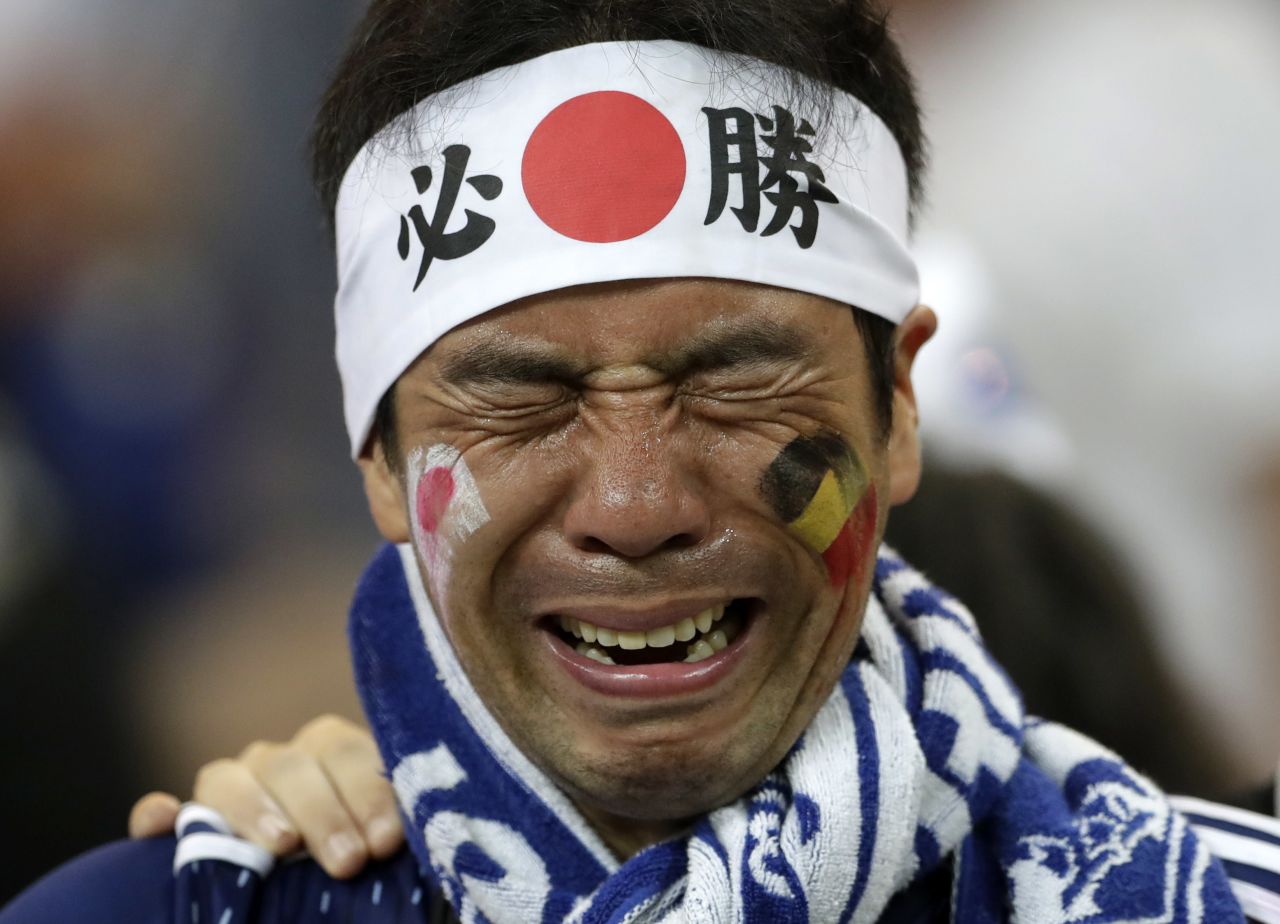 A Japan supporter cries after the match.