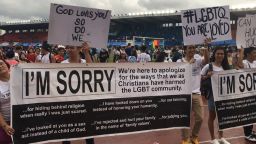 Christians hold signs and wear shirts expressing apology at a pride parade in the Philippines.