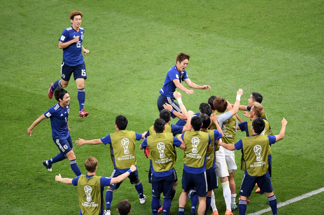 Genki Haraguchi of Japan celebrates with teammates after opening the scoring against Belgium.