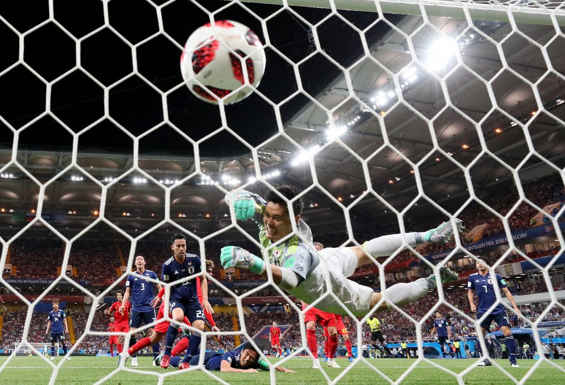 Marouane Fellaini of Belgium scores his team's second goal past Eiji Kawashima of Japan.
