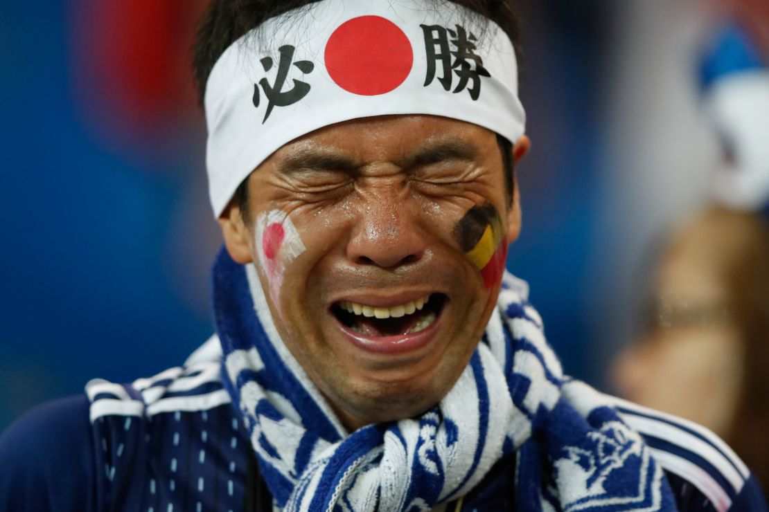 A Japan's fan cries after defeat to Belgium.