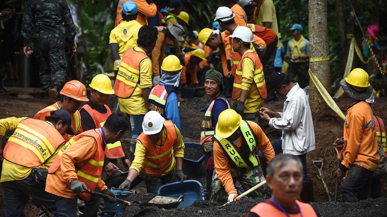Workers fix the road leading to Tham Luang cave in Khun Nam Nang Non Forest Park following news all members of children's football team and their coach were alive in the cave in Mae Sai district on July 3, 2018. - Food and medical help reached 13 members of a Thai youth football team found rake thin but alive, huddled on a ledge deep inside a flooded cave nine days after they went missing, as the focus turned on July 3 to how to get them out. (Photo by Lillian SUWANRUMPHA / AFP)        (Photo credit should read LILLIAN SUWANRUMPHA/AFP/Getty Images)
