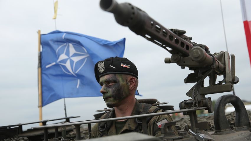ZAGAN, POLAND - JUNE 18: A soldier of the Polish Army sits in a tank as a NATO flag flies behind during the NATO Noble Jump military exercises of the VJTF forces on June 18, 2015 in Zagan, Poland. The VJTF, the Very High Readiness Joint Task Force, is NATO's response to Russia's annexation of Crimea and the conflict in eastern Ukraine. Troops from Germany, Norway, Belgium, Poland, Czech Republic, Lithuania and Belgium were among those taking part today. (Photo by Sean Gallup/Getty Images)