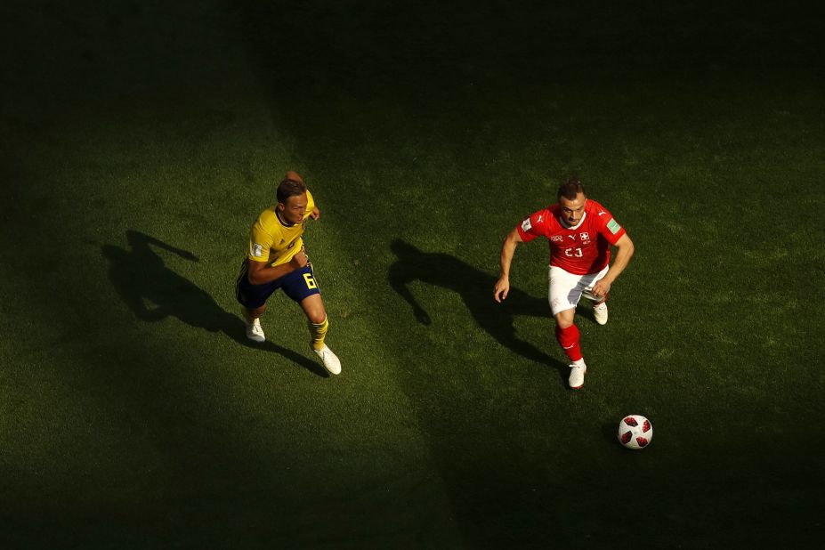 Switzerland's Xherdan Shaqiri is challenged by Ludwig Augustinsson.