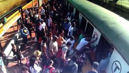 Commuters on Boston's Orange Line rock a subway train to help free a woman whose leg was trapped between the train and the platform.