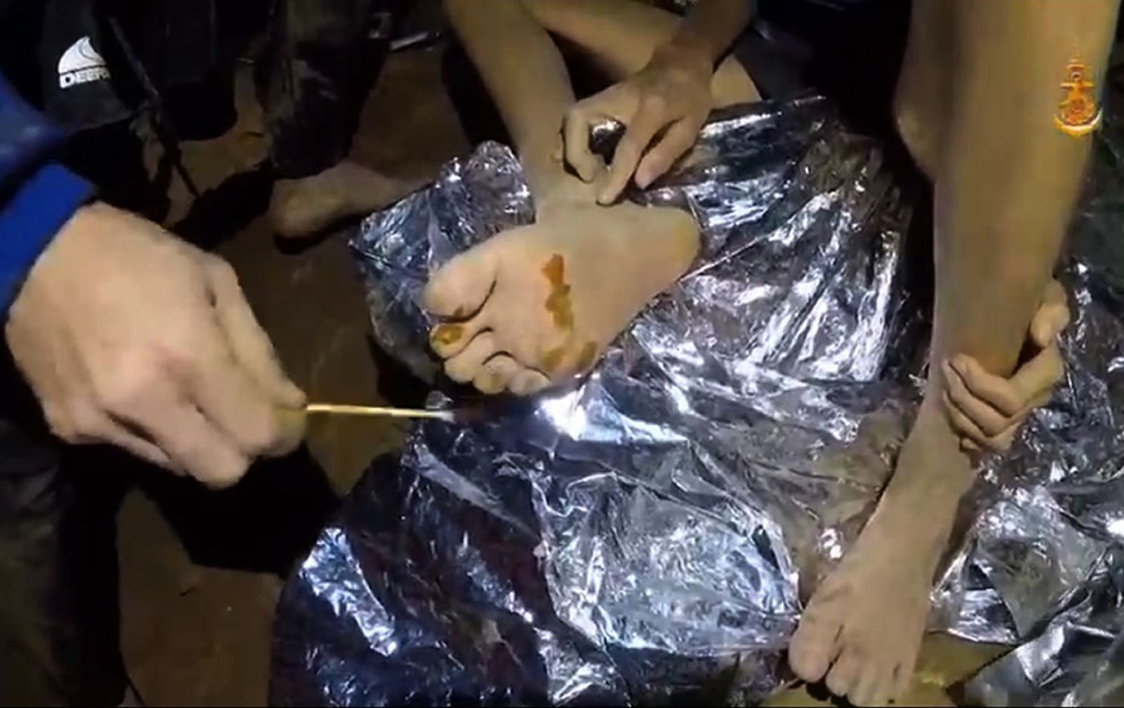 A Thai military medic provides first aid to one of the boys.