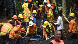 Workers fix the road leading to Tham Luang cave in Khun Nam Nang Non Forest Park following news all members of children's football team and their coach were alive in the cave in Mae Sai district on July 3, 2018. - Food and medical help reached 13 members of a Thai youth football team found rake thin but alive, huddled on a ledge deep inside a flooded cave nine days after they went missing, as the focus turned on July 3 to how to get them out. (Photo by Lillian SUWANRUMPHA / AFP)        (Photo credit should read LILLIAN SUWANRUMPHA/AFP/Getty Images)