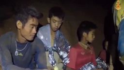 epa06862806 A video grab handout made available by Thai Royal Navy shows some of the members of a trapped soccer team in a section of Tham Luang cave in Khun Nam Nang Non Forest Park, Chiang Rai province, Thailand, 04 July 2018. Chiang Rai provincial Governor Narongsak Osatanakorn said on 02 July that all of 13 members of a youth soccer team, including their coach, had been found alive in a cave after they went missing over a week prior. Rescuers have delivered supplies and food into the cave to sustain the team while there extraction is planned.  EPA-EFE/ROYAL THAI NAVY / HANDOUT HANDOUT EDITORIAL USE ONLY/ NO SALES HANDOUT EDITORIAL USE ONLY/NO SALES