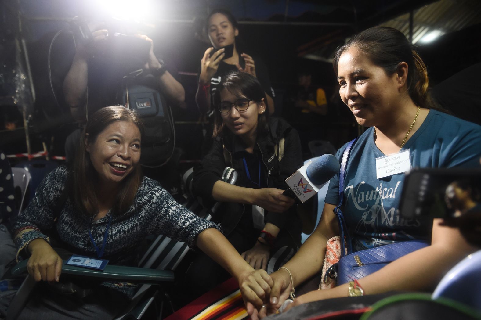 Some of the team's family members celebrate after receiving news that the team was alive.