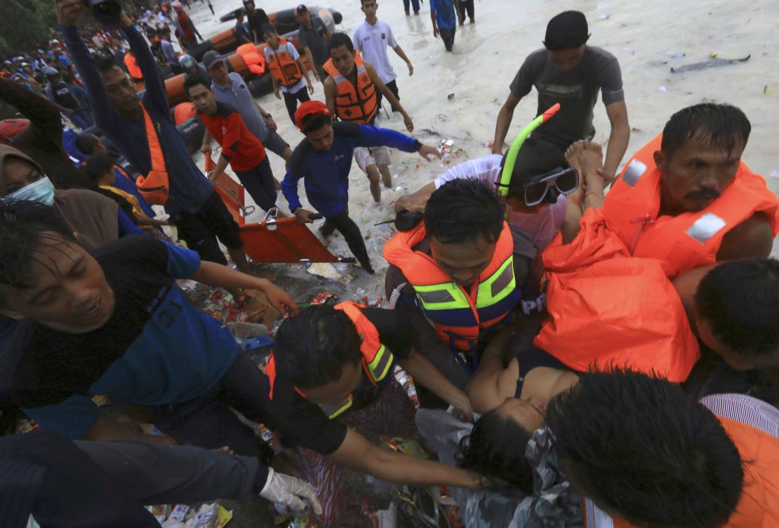 Rescuers remove a passenger from the sinking  KM Lestari Maju ferry.
