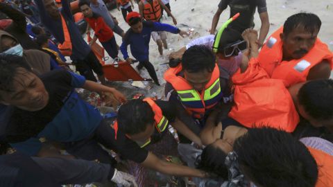 Rescuers remove a passenger from the sinking KM Lestari Maju ferry.