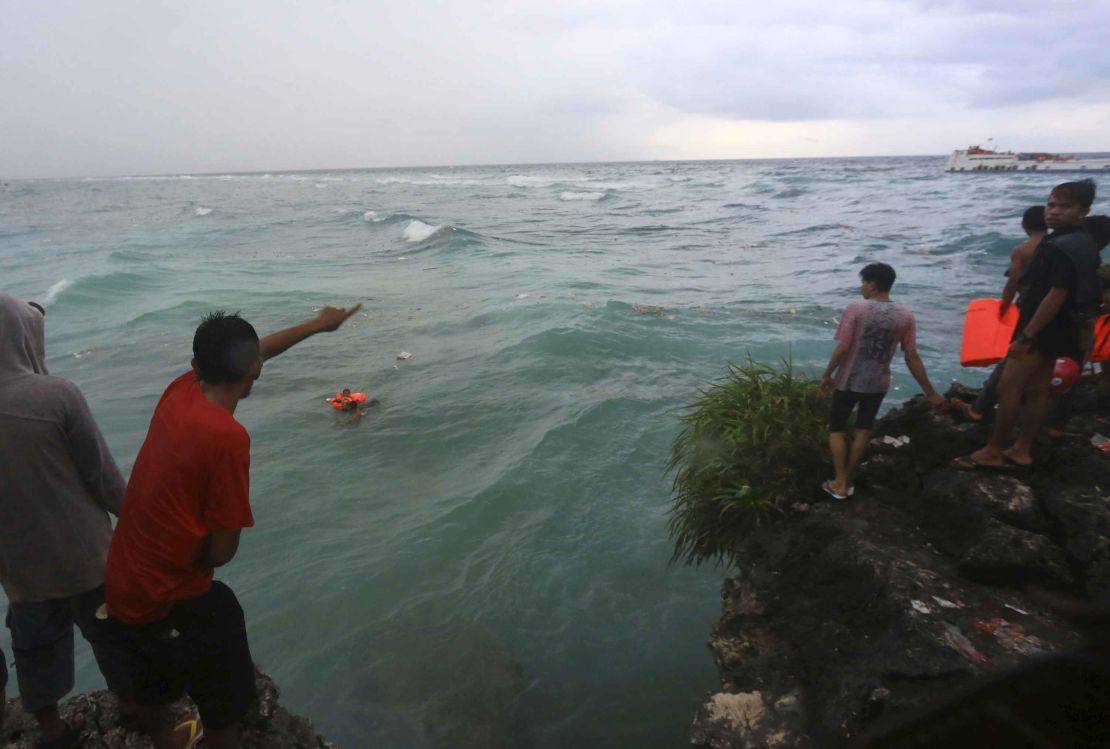 Residents attempt to rescue victims of the sinking ferry Lestari Maju.