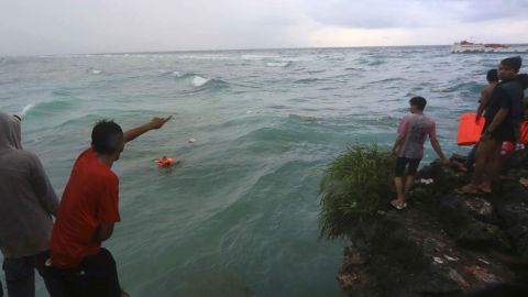 Residents attempt to rescue victims of the sinking ferry Lestari Maju.