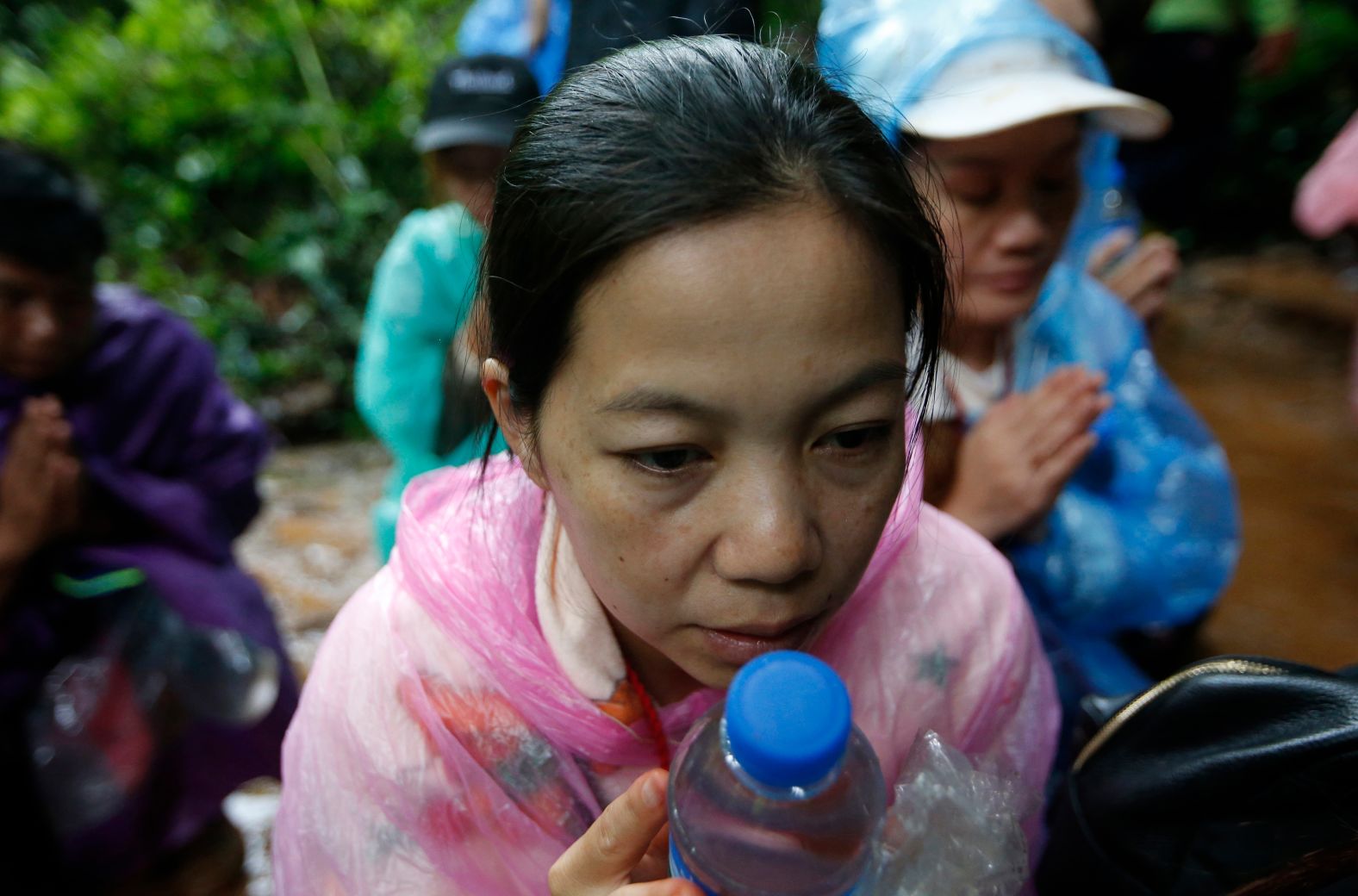 Relatives of the trapped team members pray on June 27.