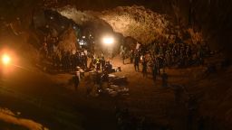 TOPSHOT - Thai soldiers relay electric cable deep into the Tham Luang cave at the Khun Nam Nang Non Forest Park in Chiang Rai on June 26, 2018 during a rescue operation for a missing children's football team and their coach. - Desperate parents led a prayer ceremony outside a flooded cave in northern Thailand where 12 children and their football coach have been trapped for days, as military rescue divers packing food rations resumed their search on June 26. (Photo by Lillian SUWANRUMPHA / AFP)        (Photo credit should read LILLIAN SUWANRUMPHA/AFP/Getty Images)