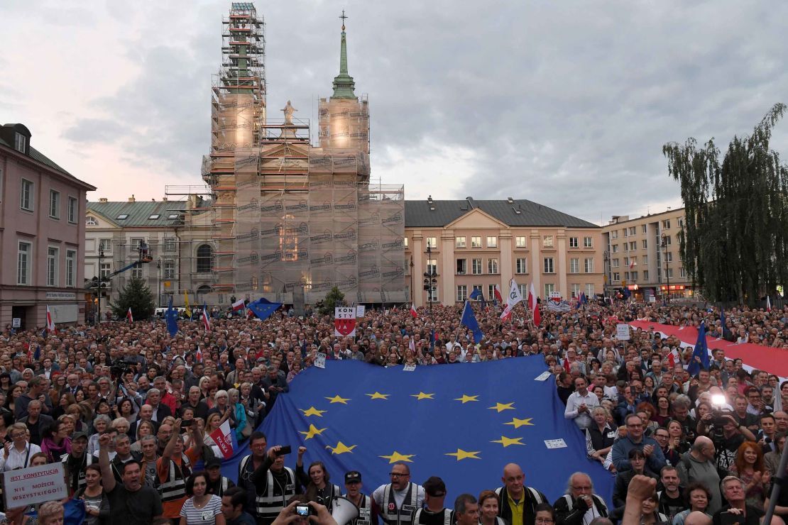 People demonstrate in support of the Supreme Court judges in front of the Supreme Court building in Warsaw on Tuesday evening.