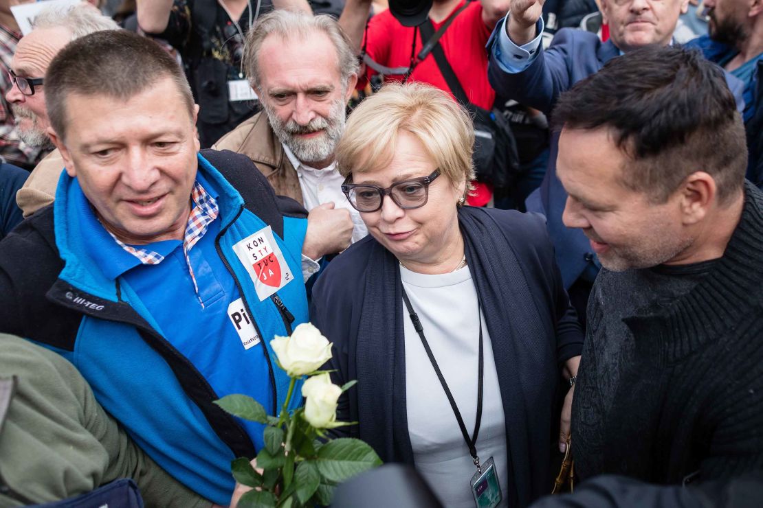 Polish Supreme Court Justice president Malgorzata Gersdorf, center, arrives for work Wednesday at the Supreme Court building in Warsaw as people gather to support her.