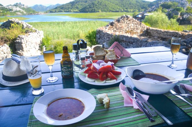 <strong>Table with a view: </strong>Lunch could start with home-cured ham called prsut, local tomatoes in a salad, before fried carp served with homemade bread. Shots of a fiery homebrew liquor called rakija help ensure a snoozy afternoon.