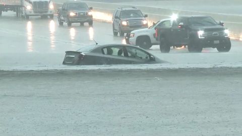 A car is engulfed by water on a Houston road Wednesday.