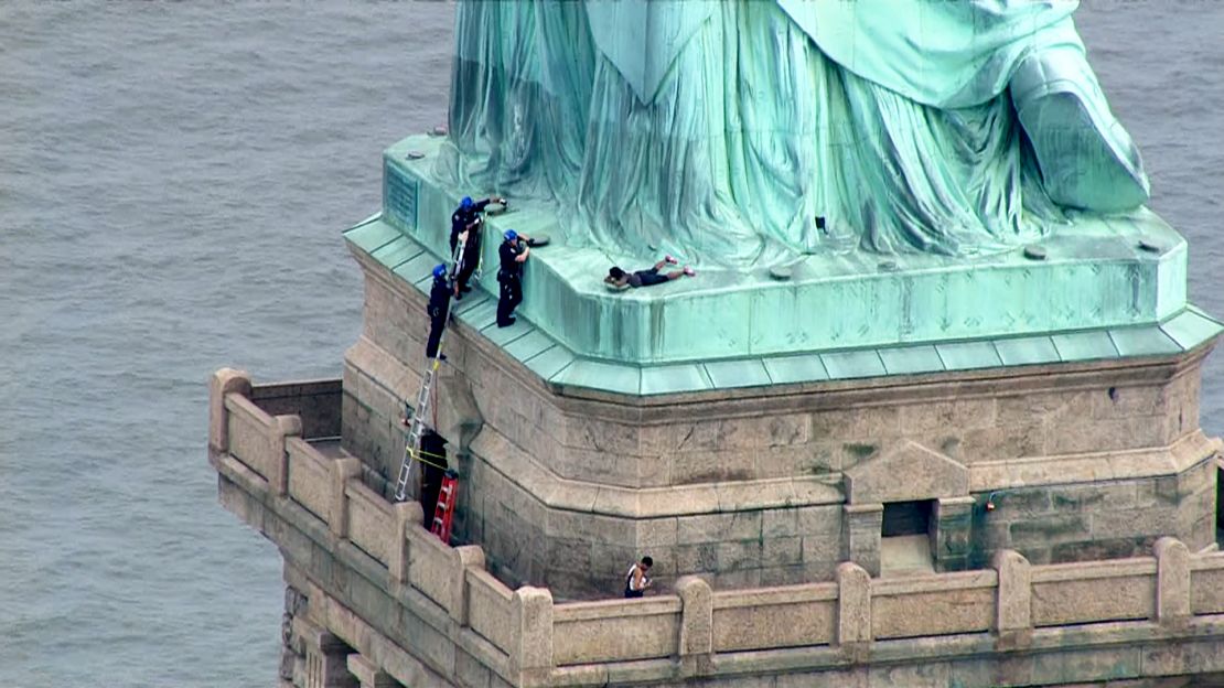 Therese Okoumou faces charges related to her climb of the base of the Statue of Liberty on Wednesday.