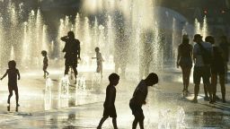 Children play in the water fountains at the Place des Arts in Montreal, Canada on a hot summer day July 3, 2018. Eva Hambach/AFP/Getty Images
