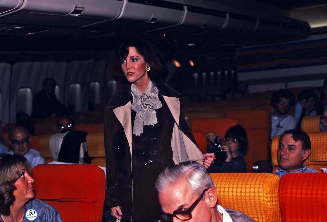 Pan Am flight attendant, Siri Giberson, models an outfit during an onboard fashion show.