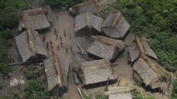 An aerial view of a village called Irotatheri as Yanomami Indians stand at the main courtyard in Venezuela's Amazon region.