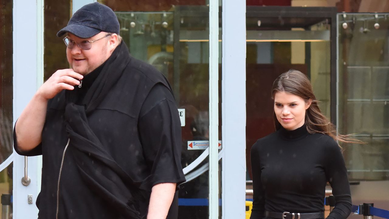 Kim Dotcom leaves with his girlfriend Elizabeth Donelly following his extradition appeal at the High Court in Auckland on August 29, 2016.