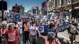 LONDON, UNITED KINGDOM - 2018/06/30: Members of the march organization holding hands.Tens of thousands of people marched during the hot Saturday weather through London to celebrate and demonstrate over Britain's National Health Service (NHS), ahead of its 70th birthday next week. (Photo by Brais G. Rouco/SOPA Images/LightRocket via Getty Images)