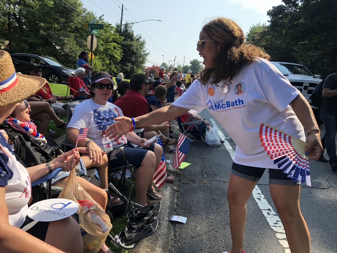 Candidate McBath greets voters at a July 4th parade.