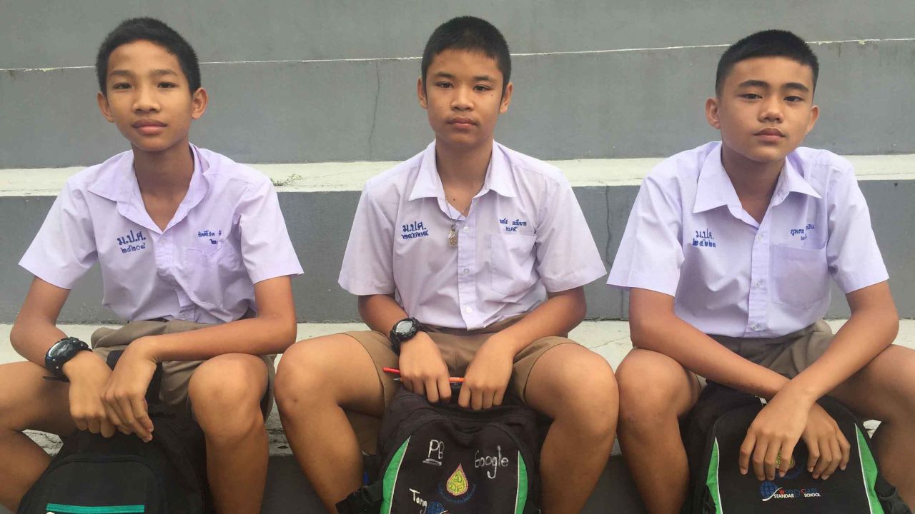 Kittichoke Konkaew (far left), Puwadet Kumngoen (far right), and a friend await news of their classmate Nuttawut Takumsong.