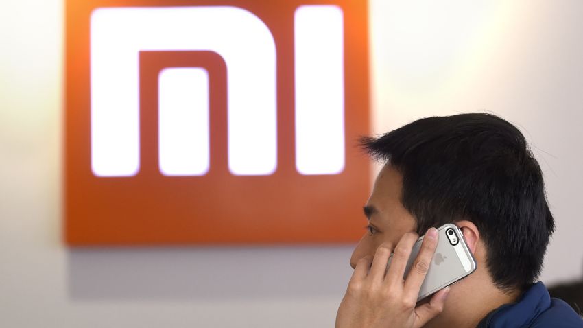 This picture taken on January 7, 2015 shows a man using his mobile phone at a Xiaomi shop in Beijing. AFP PHOTO / WANG ZHAO / AFP / WANG ZHAO (Photo credit should read WANG ZHAO/AFP/Getty Images)