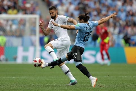 France's Olivier Giroud, left, and Uruguay's Martin Caceres battle for the ball during their quarterfinal match on July 6. France won 2-0.