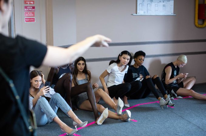 Models wait to be called for dressing backstage.