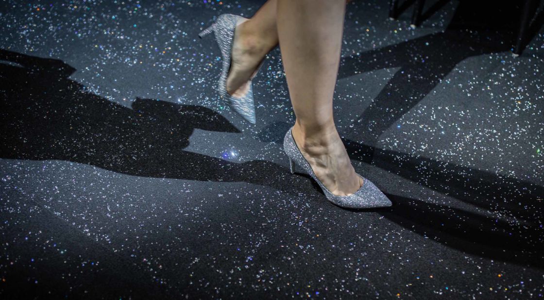 A model walks on the runway, which was scattered with Swarovski crystals.