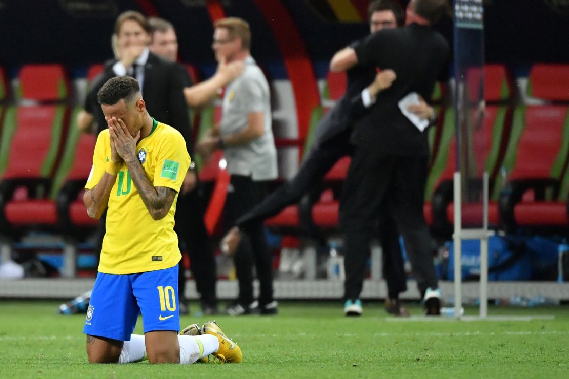 Neymar slumps to his knees after defeat against Belgium.