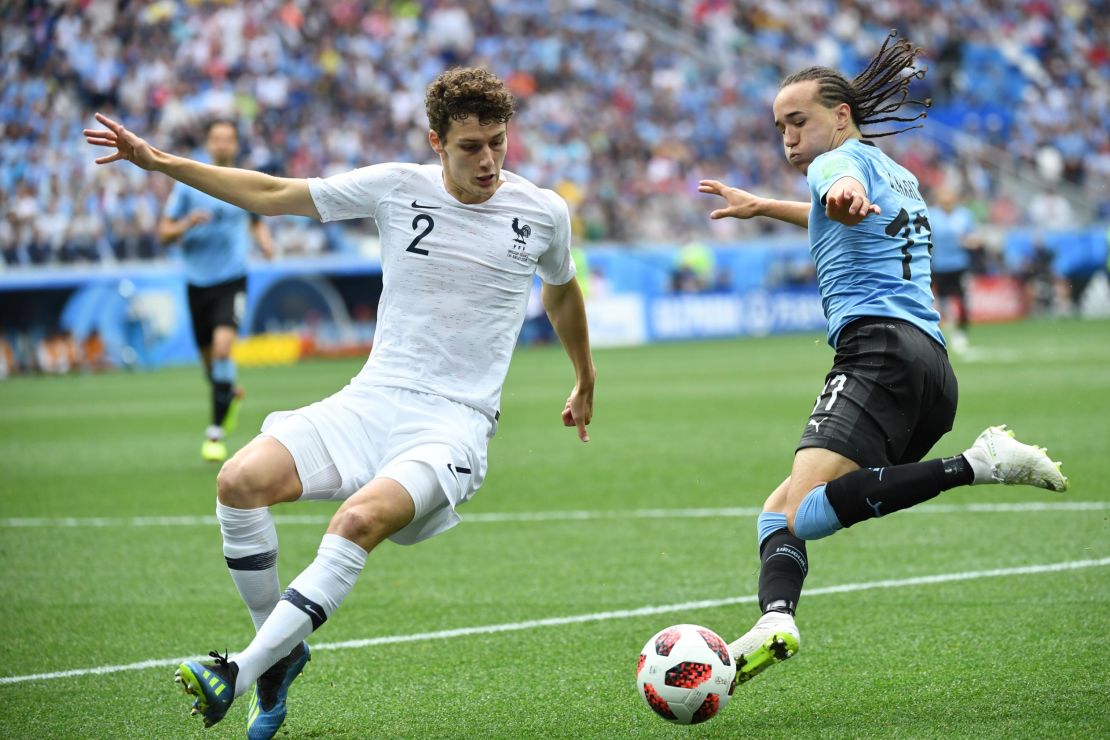 France defender Benjamin Pavard (L) vies for the ball with Uruguay defender Diego Laxalt in the World Cup. Pavard will join Bayern at the end of the season along with Hernandez.