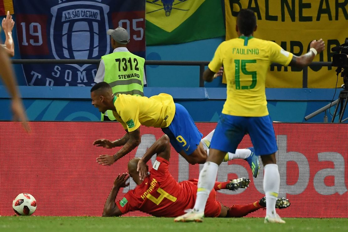Belgium's Vincent Kompany (bottom) tackles Brazil forward Gabriel Jesus.