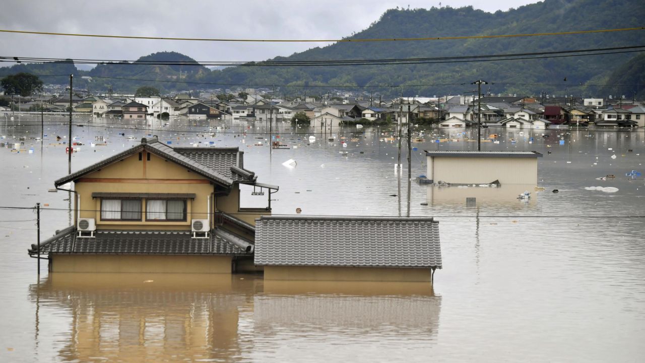 Residential buildings are partially submerged in floodwaters caused by heavy rains in Kurashiki, Okayama prefecture, southwestern Japan, Saturday, July 7, 2018.
