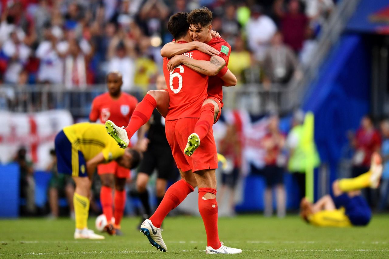 English defenders Harry Maguire, left, and John Stones celebrate their quarterfinal victory over Sweden on July 7. Maguire scored the opening goal in the 2-0 win.