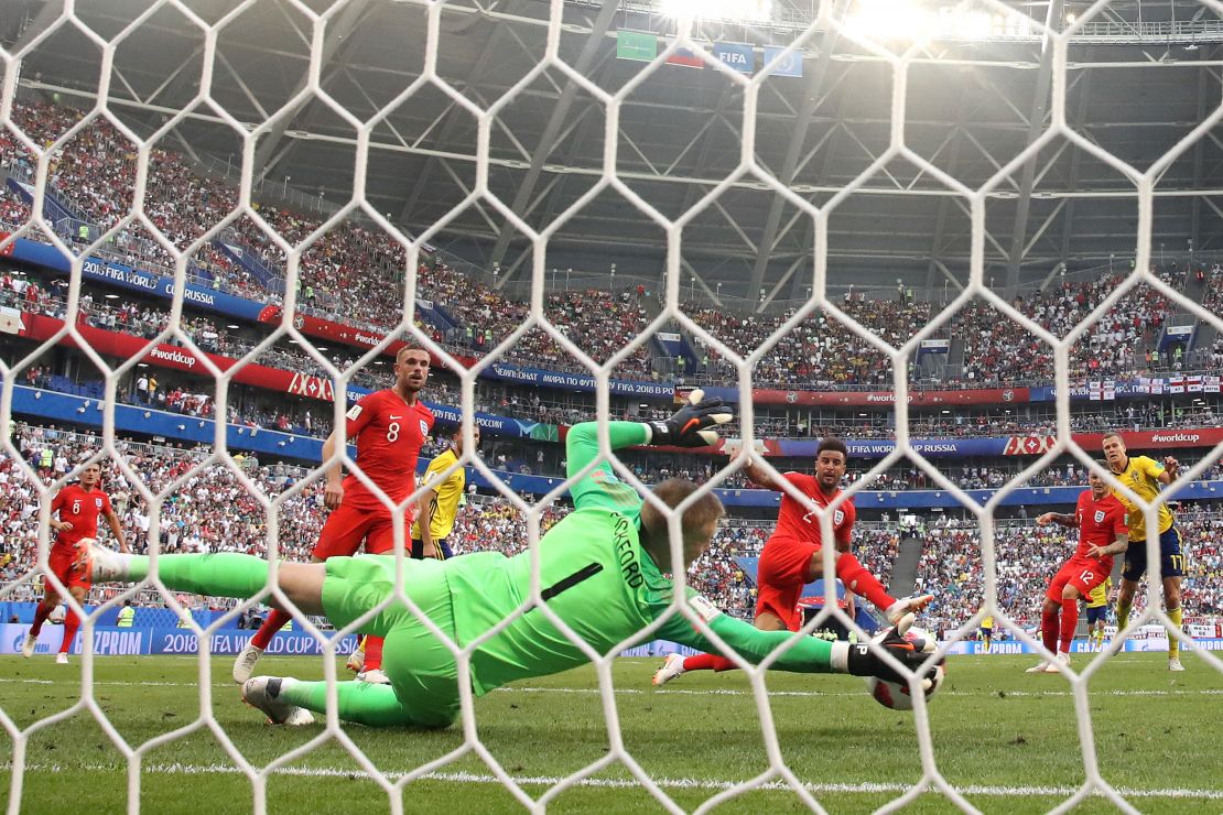 Jordan Pickford of England makes a save to keep the score at 2-0.