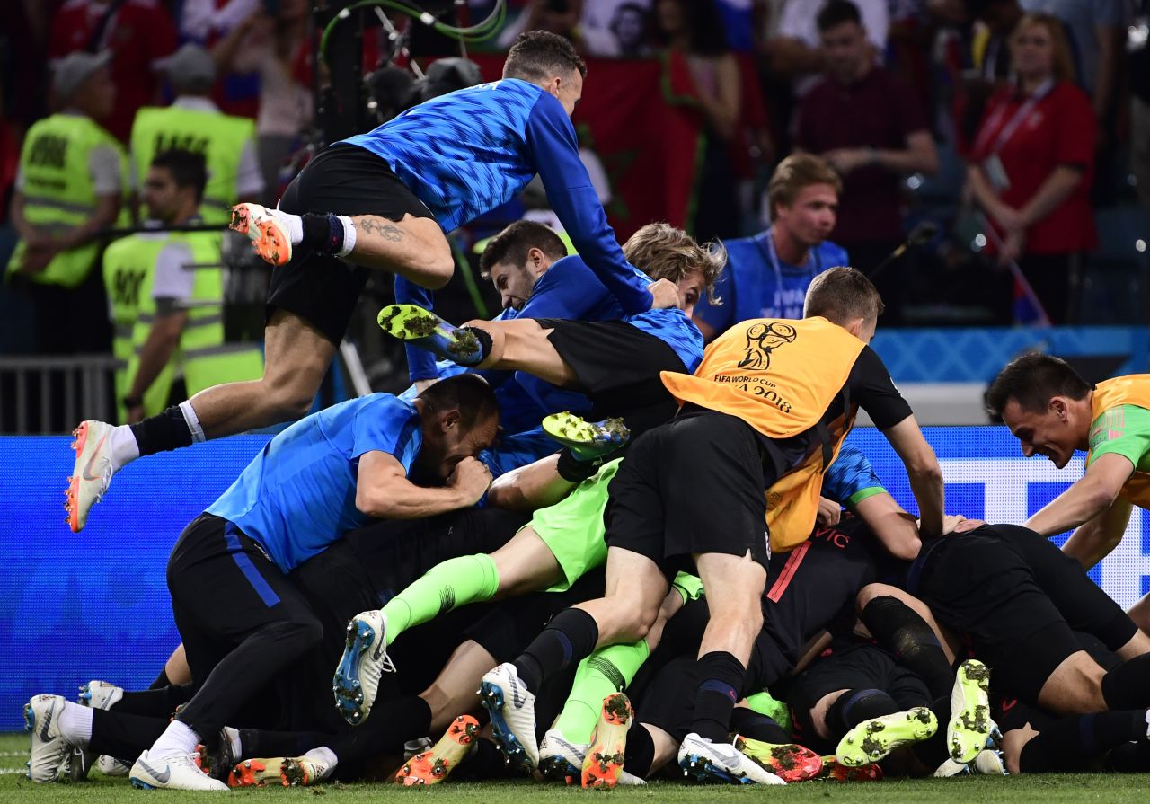 Croatian players celebrate after defeating Russia in a penalty shootout. The match was tied 2-2 after extra time.