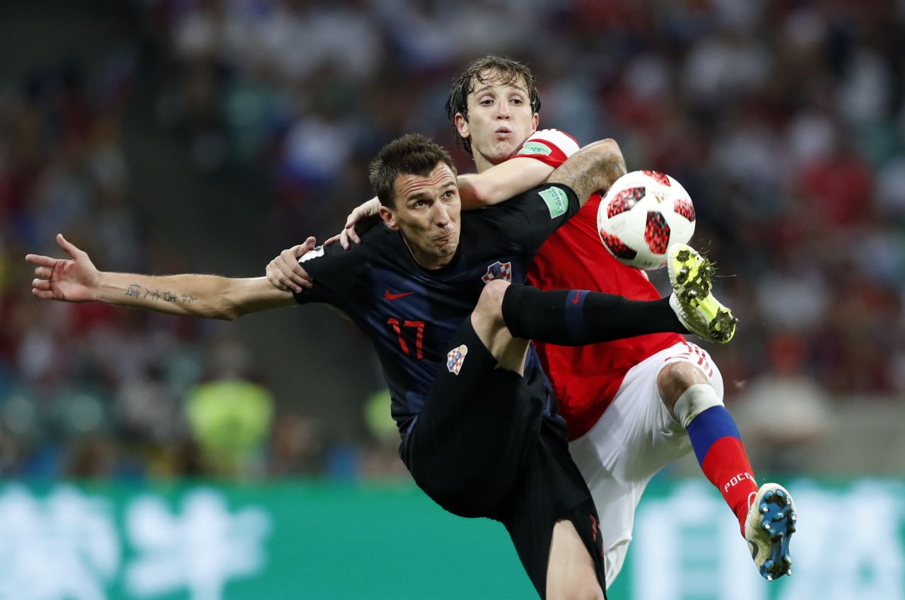 Croatia's Mario Mandzukic, left, and Russia's Mario Fernandes go for the ball.