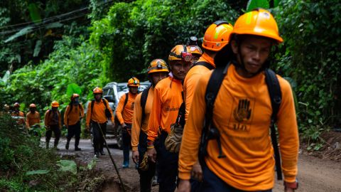 Men from the Department of Disaster Prevention and Mitigation arrive to the cave entrance on July 6, in Chiang Rai, Thailand.