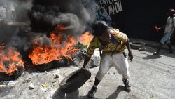 TOPSHOT - Protesters barricade a street in the Port-au-Prince suburb of Petion-Ville on July 7, 2018, to protest against the increase in fuel prices.

Haiti's Prime Minister, Jack Guy Lafontant, on Saturday called for patience from residents of the Caribbean nation amid deadly protests over an unpopular fuel price rise. At least one person has died there in the past day. The capital has stood paralyzed since July 6, following the government announcement that gasoline prices would rise by 38 percent, diesel by 47 percent and kerosene by 51 percent starting this weekend. 
 / AFP PHOTO / HECTOR RETAMALHECTOR RETAMAL/AFP/Getty Images