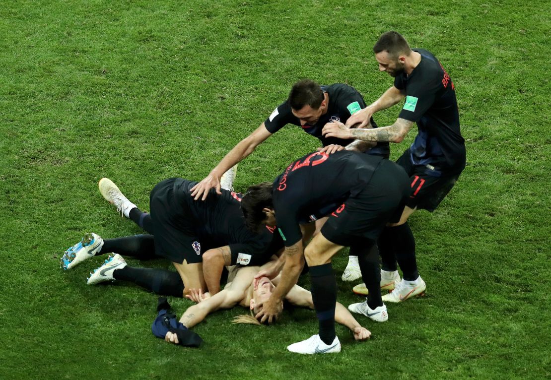 Domagoj Vida is mobbed by his teammates after scoring the winner.
