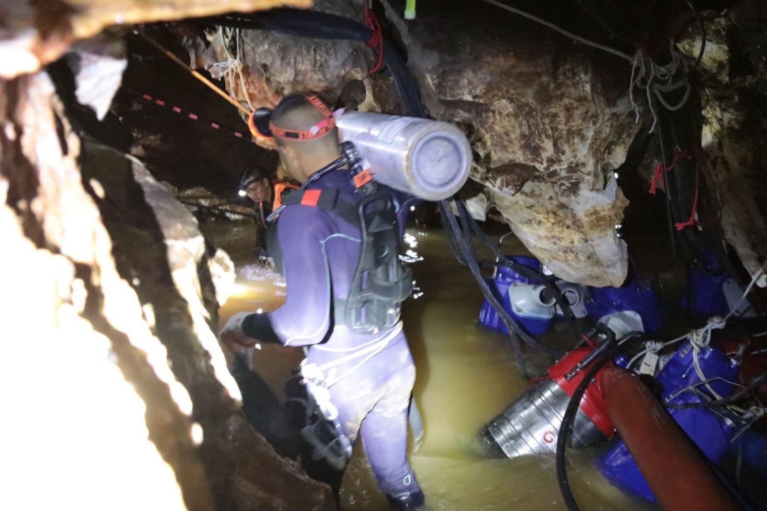 Emergency workers carry oxygen tanks as rescue operations begin.