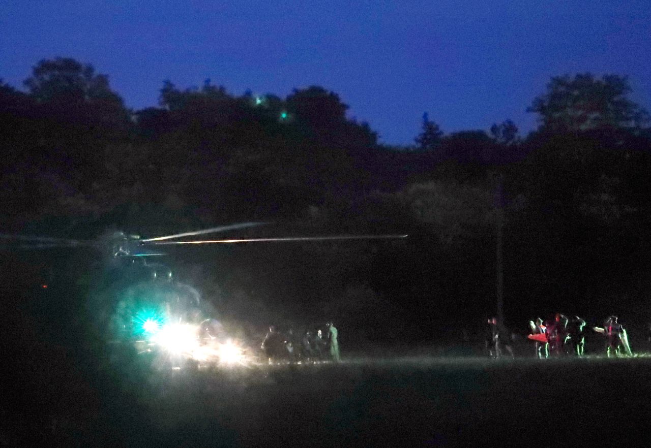 Emergency responders surround a helicopter on July 8.